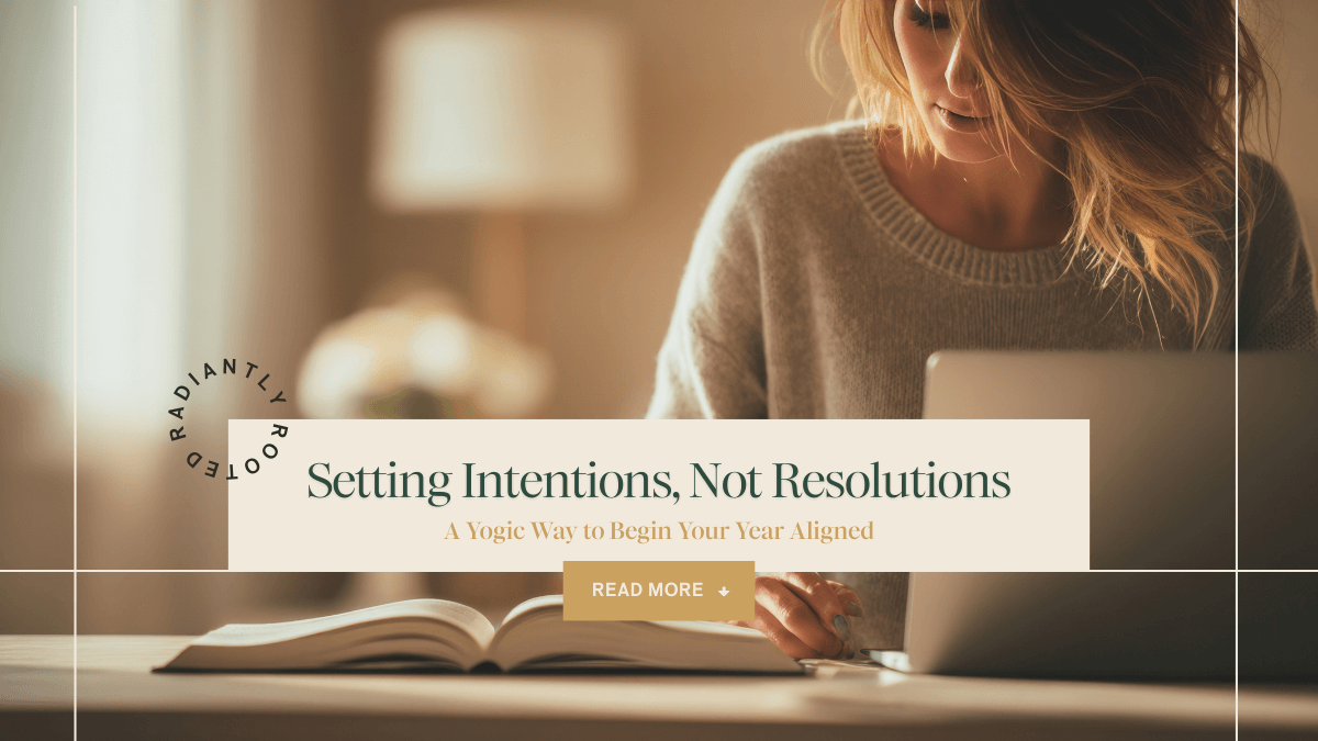 Woman journaling at a desk with a laptop and open notebook in warm, soft light. Text overlay reads ‘Setting Intentions, Not Resolutions: A Yogic Way to Begin Your Year Aligned.’